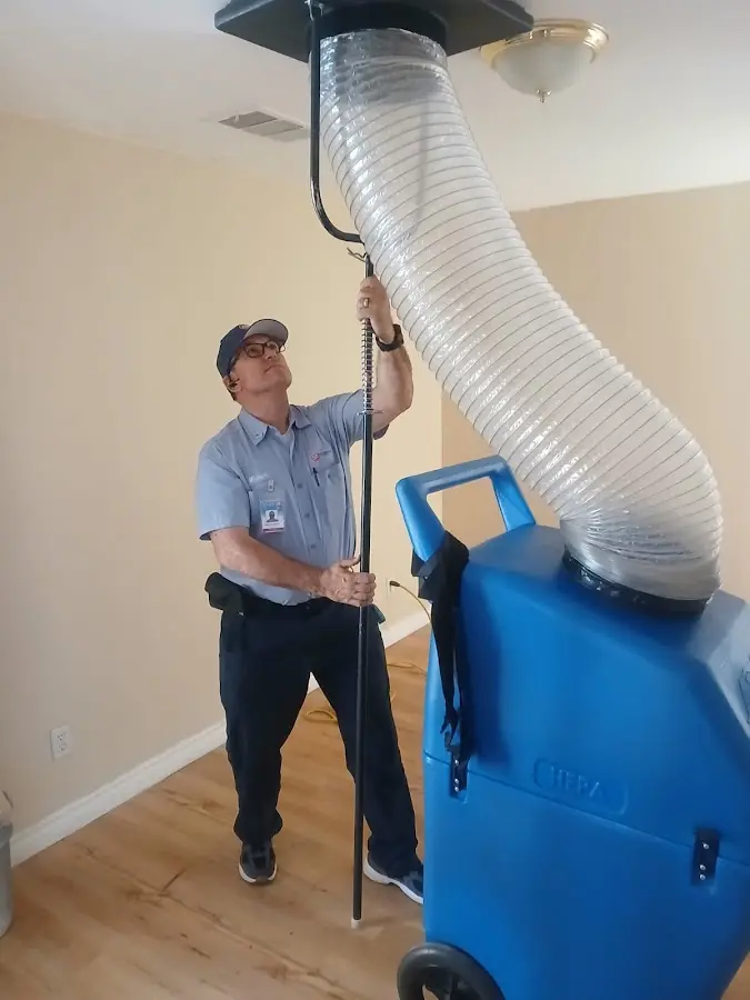 Furnace Tune-Up technician using HEPA equipment in Cinco Ranch