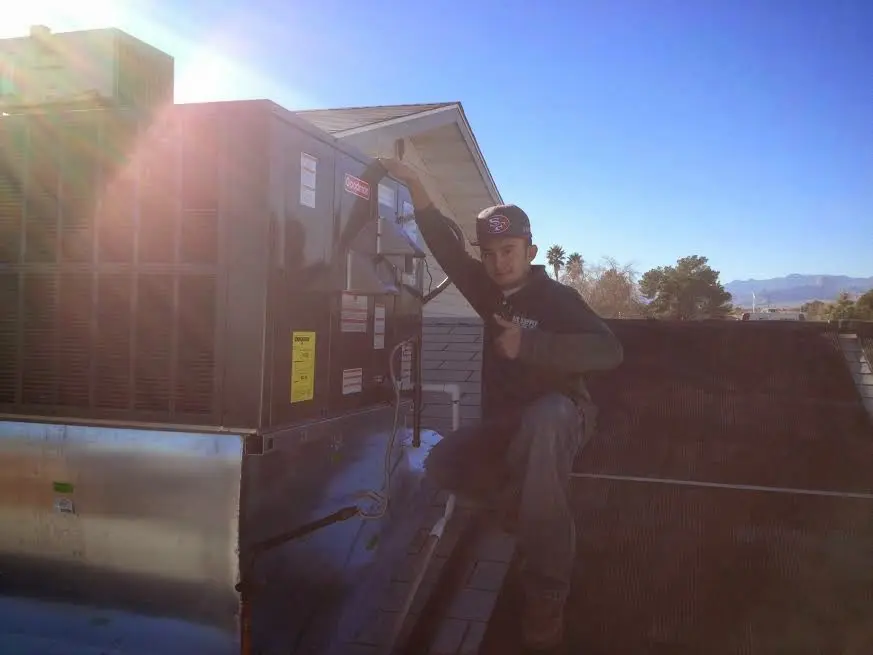 HVAC technician performing HVAC Inspection on a rooftop unit in Cinco Ranch